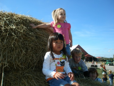 Kasen and Sarah climbing on the hay